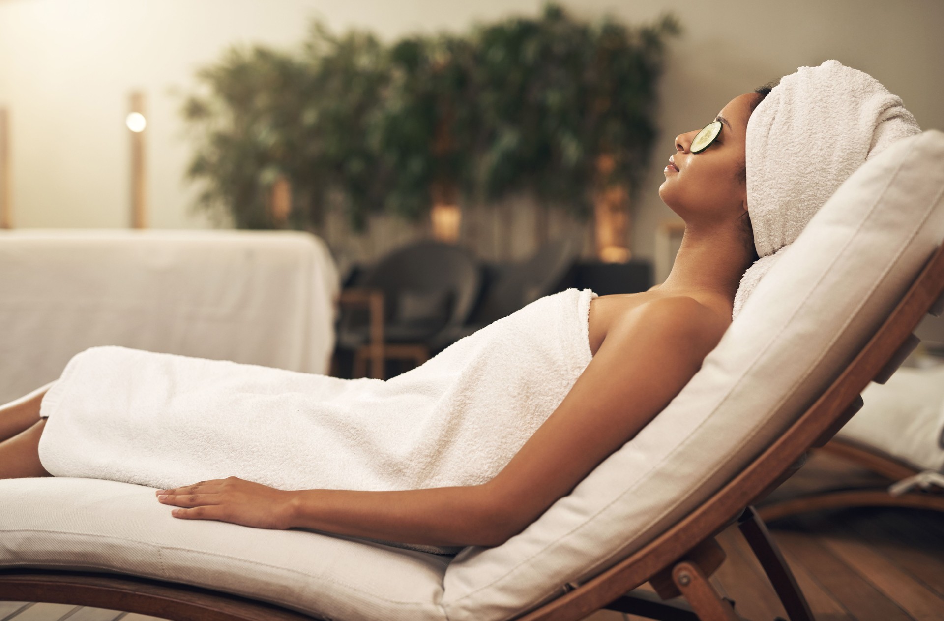 Shot of a woman relaxing in a spa with cucumber slices on her eyes